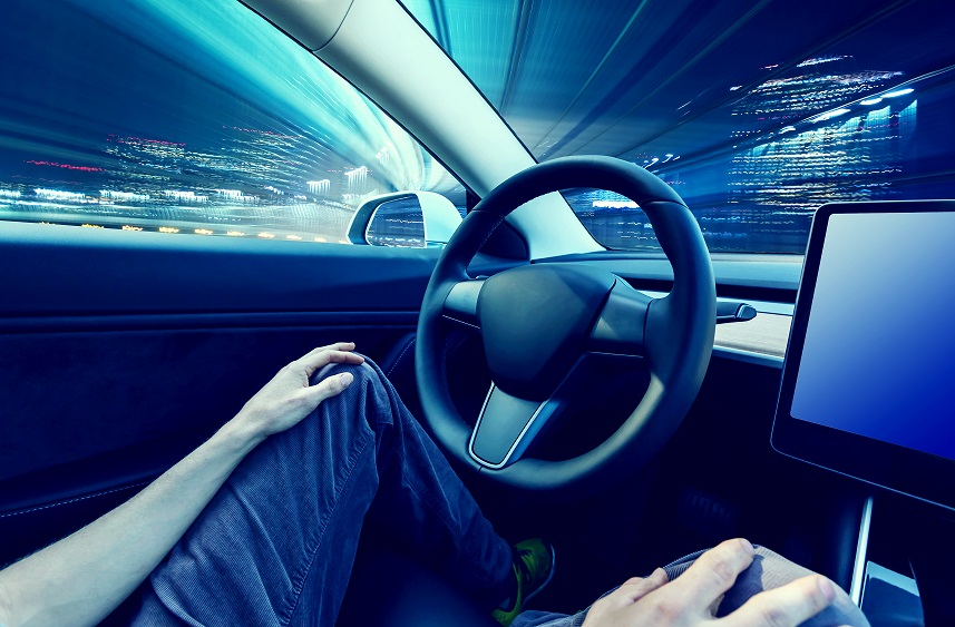Person using car in autopilot mode hands free